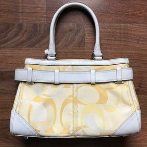 Women’s yellow Coach brand handbag/purse.
